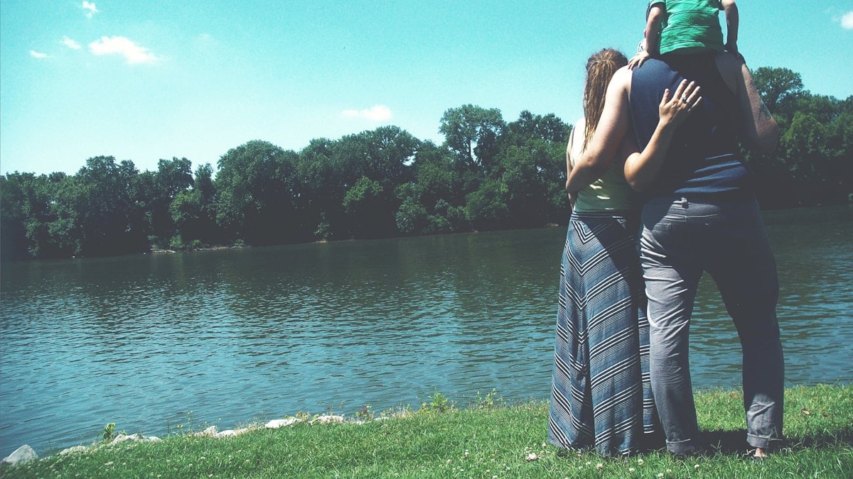 Family standing by lake